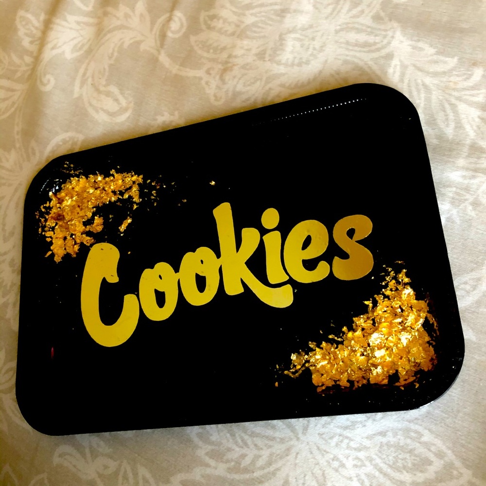 Black cookies tray with golden flakes